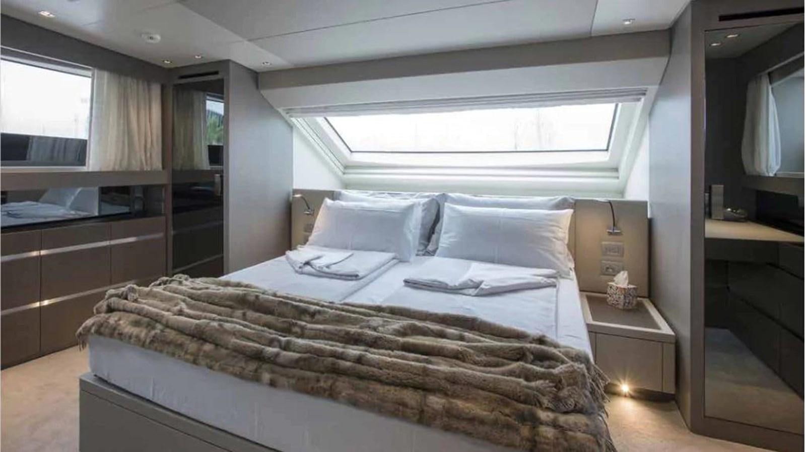 a bed with a white comforter aboard MUMA Yacht for Sale