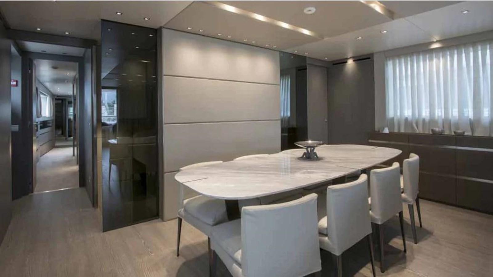 a large conference room with a table and chairs aboard MUMA Yacht for Sale