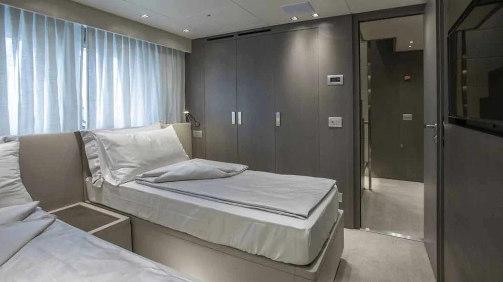 a room with a bed and a door aboard MUMA Yacht for Sale