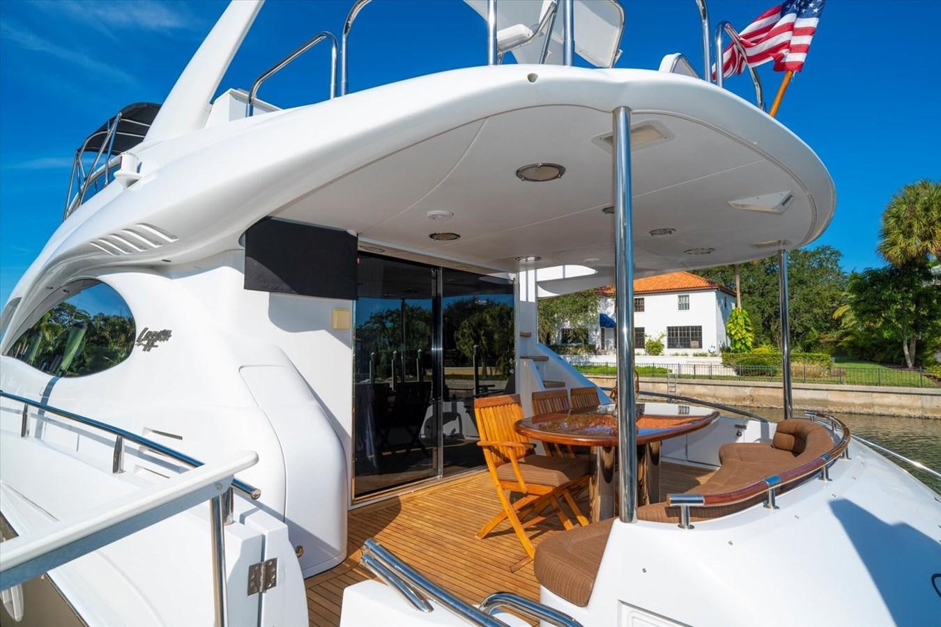 a boat with a table and chairs outside aboard GOLDEN LADY Yacht for Sale