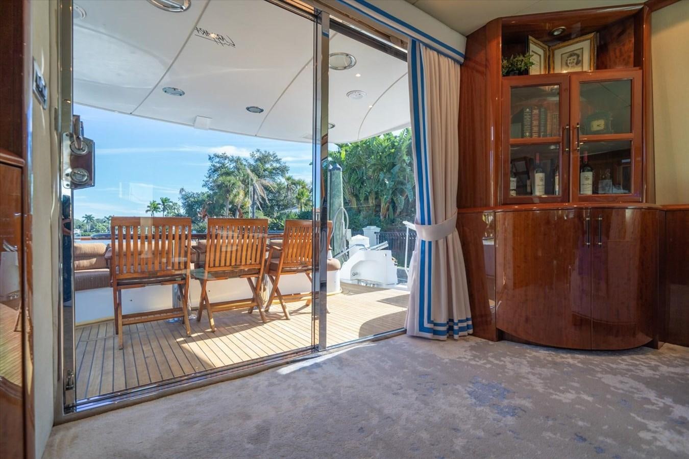 a room with a table chairs and a door aboard GOLDEN LADY Yacht for Sale