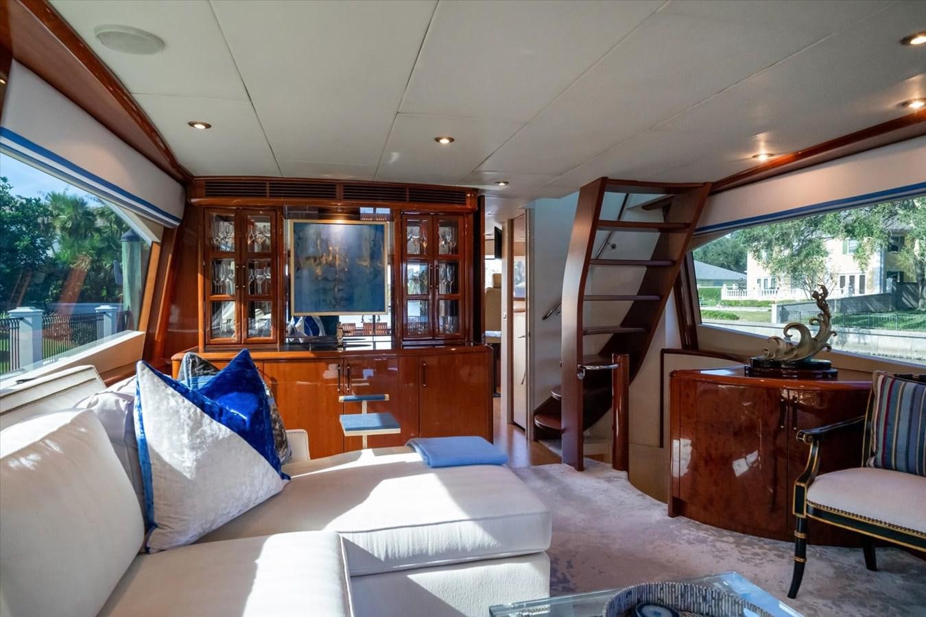 a living room with a white couch and a wood coffee table aboard GOLDEN LADY Yacht for Sale