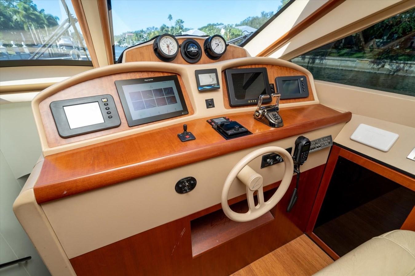 a wooden desk with a few electronic devices on it aboard GOLDEN LADY Yacht for Sale