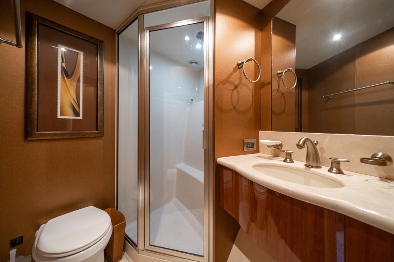 a bathroom with a glass shower door aboard GOLDEN LADY Yacht for Sale