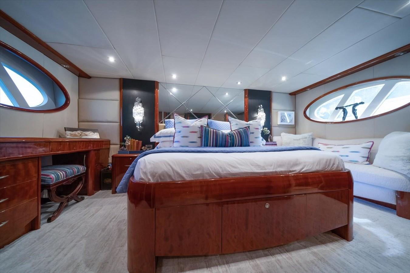 a bedroom with a bed and a desk aboard GOLDEN LADY Yacht for Sale