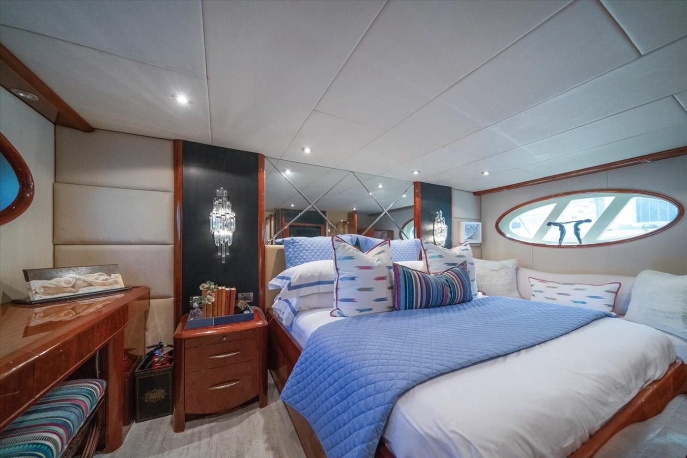 a bedroom with a bed and a mirror aboard GOLDEN LADY Yacht for Sale