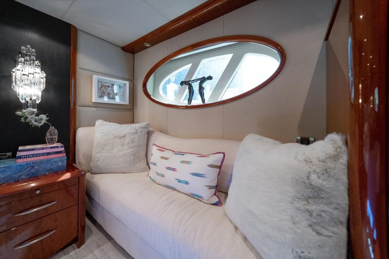 a bed with a painting on the wall aboard GOLDEN LADY Yacht for Sale