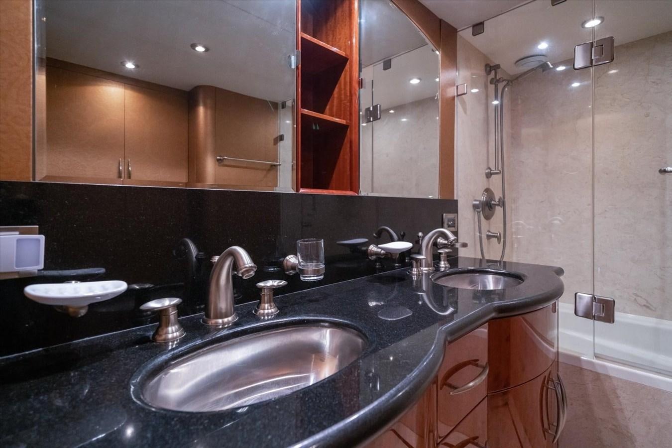a bathroom with a sink and a large mirror aboard GOLDEN LADY Yacht for Sale