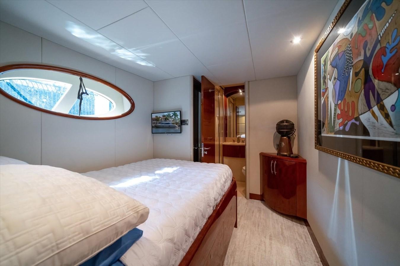 a bedroom with a painting on the wall aboard GOLDEN LADY Yacht for Sale