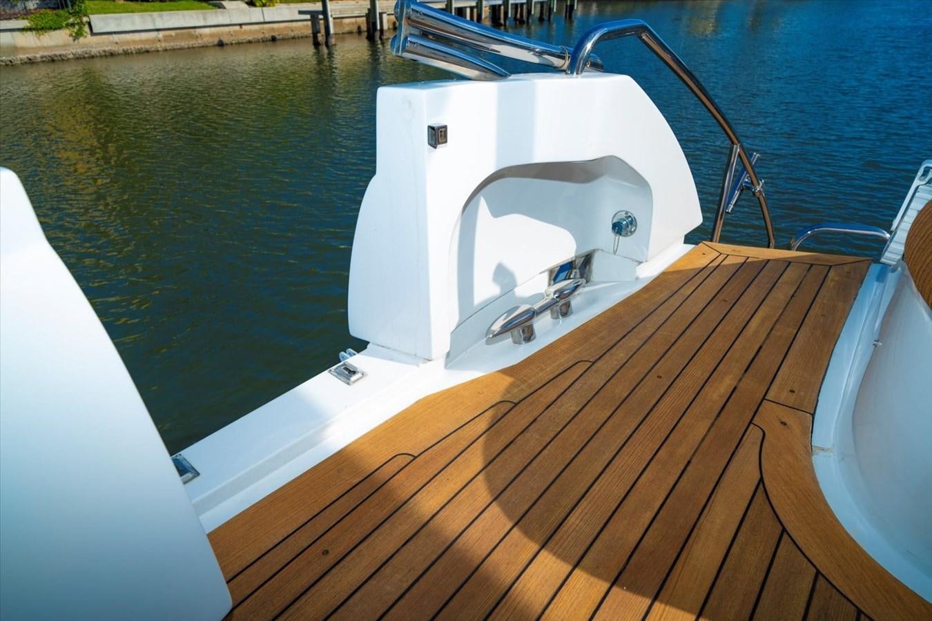 a white boat with a wooden dock aboard GOLDEN LADY Yacht for Sale