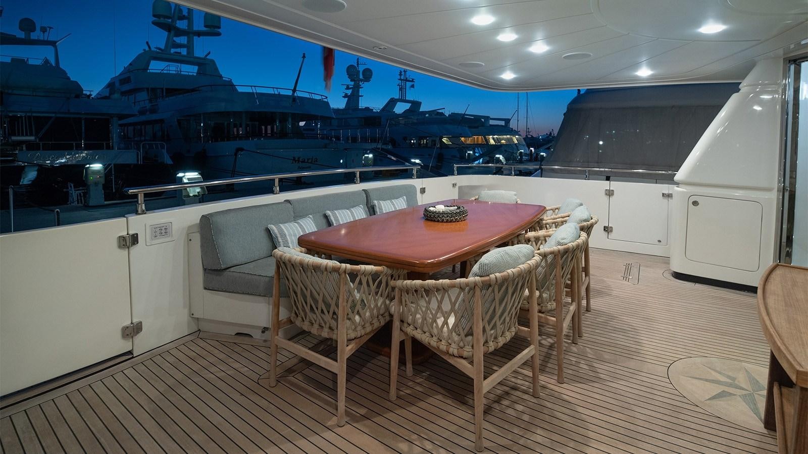 a room with a table and chairs aboard DIAMARE Yacht for Sale