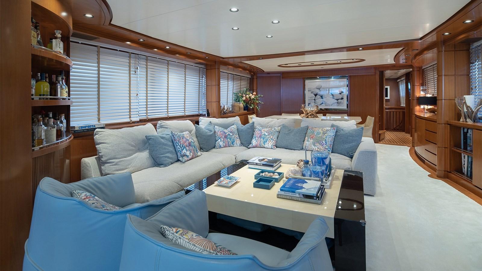 a living room with a couch and a coffee table aboard DIAMARE Yacht for Sale