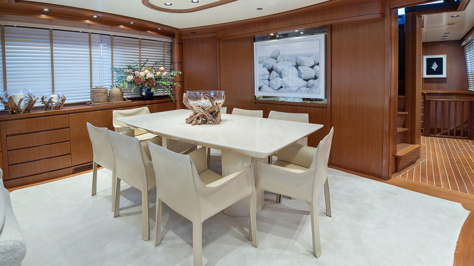 a room with a table and chairs aboard DIAMARE Yacht for Sale