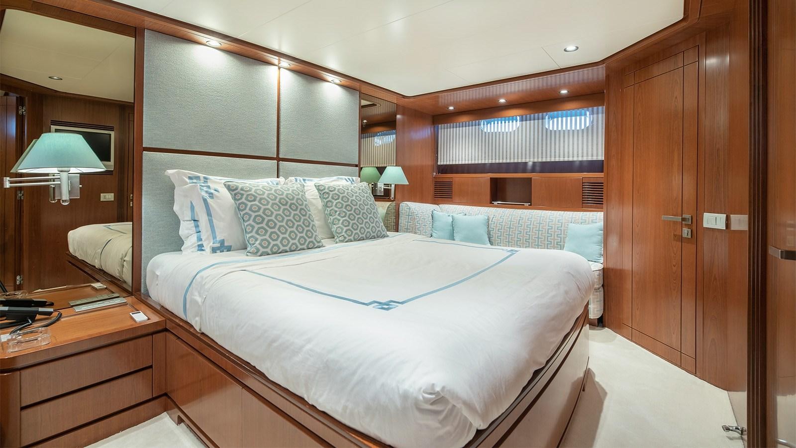 a room with a bed and a desk aboard DIAMARE Yacht for Sale