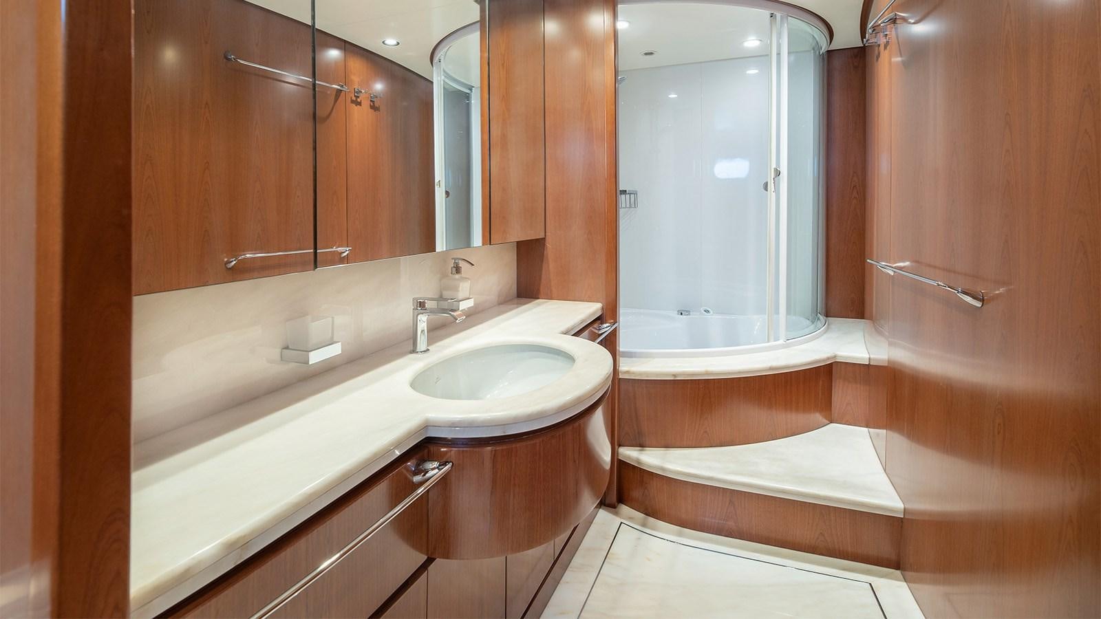 a bathroom with a tub sink and a mirror aboard DIAMARE Yacht for Sale
