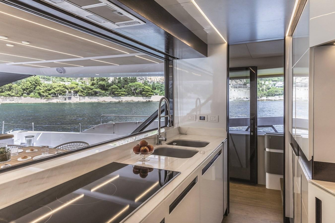 a kitchen with a large window aboard SONEY Yacht for Sale