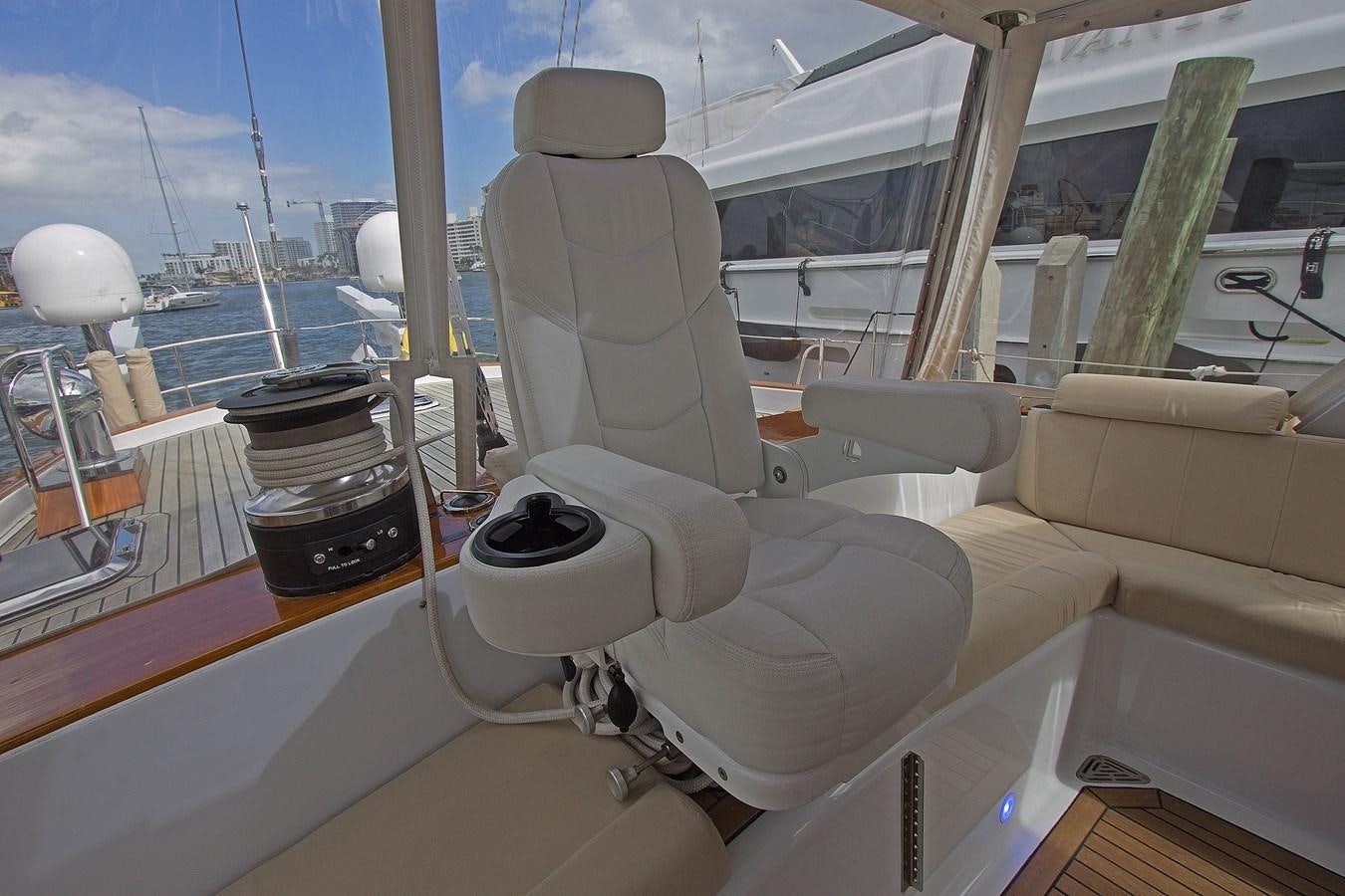 a white chair on a boat aboard EAGLES NEST Yacht for Sale
