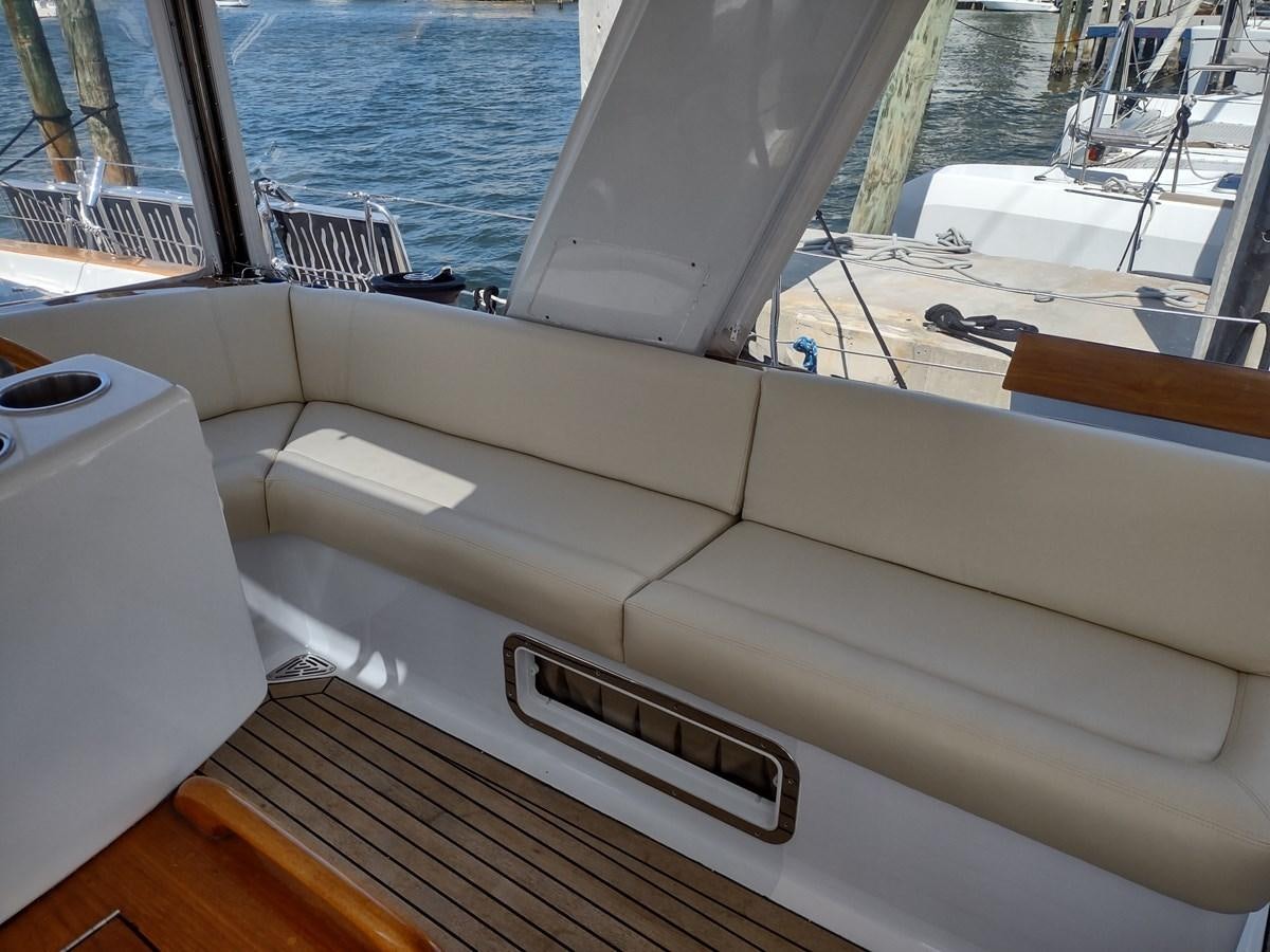 a white boat on a deck aboard EAGLES NEST Yacht for Sale