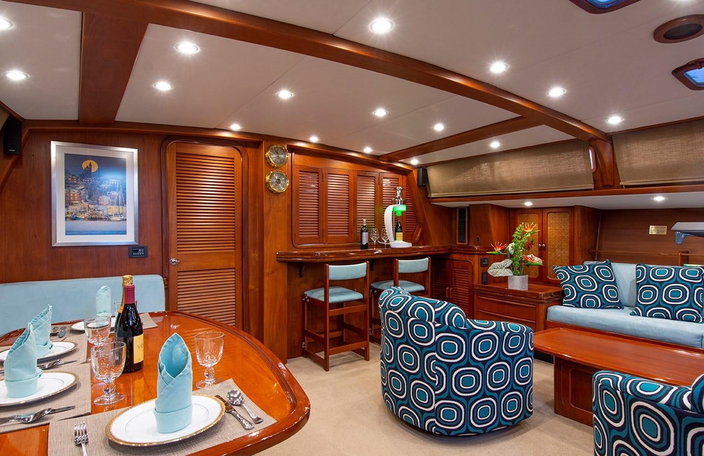 a room with a table and chairs aboard EAGLES NEST Yacht for Sale