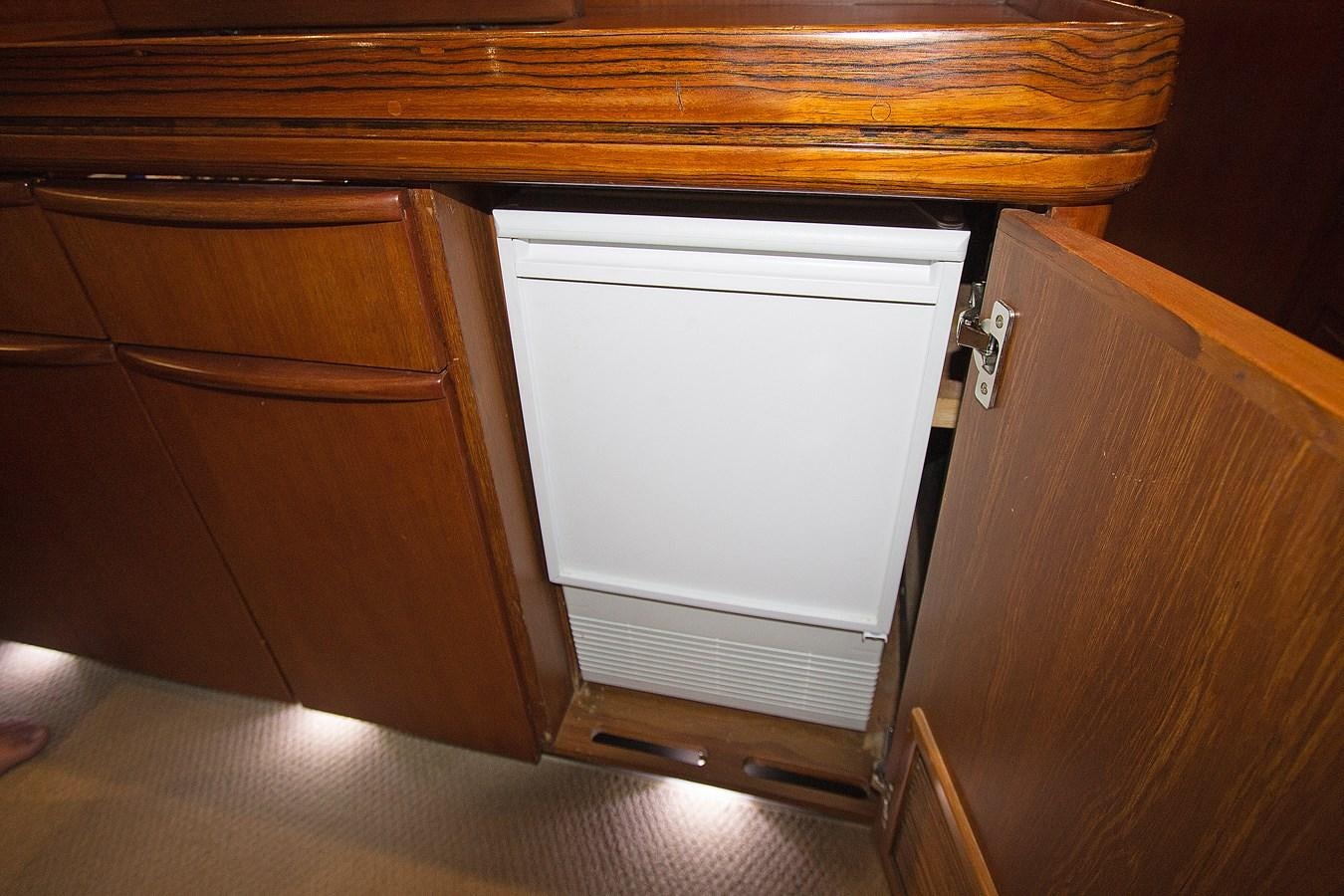 a white rectangular object on a wooden surface aboard EAGLES NEST Yacht for Sale