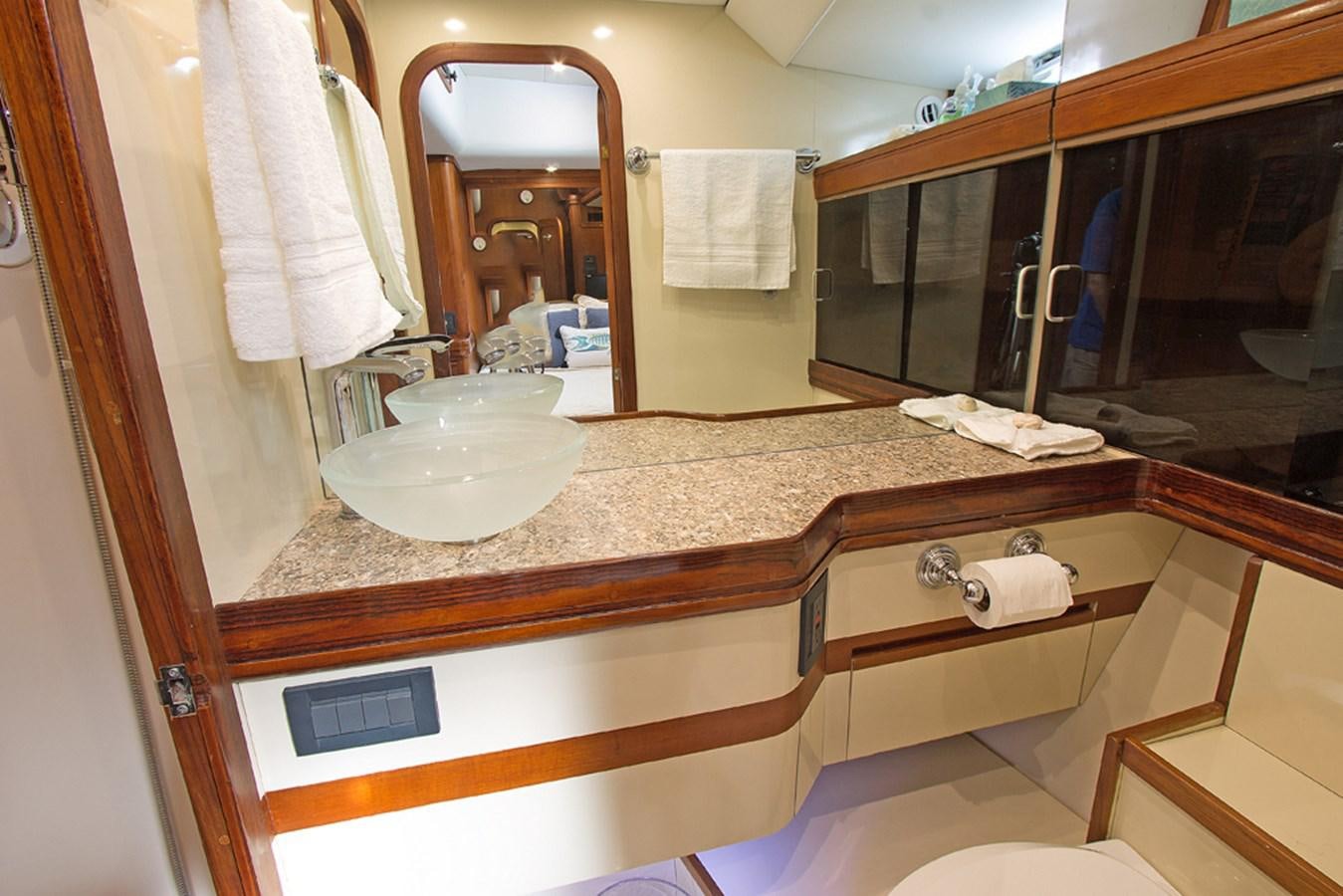 a bathroom with a countertop sink and mirror aboard EAGLES NEST Yacht for Sale