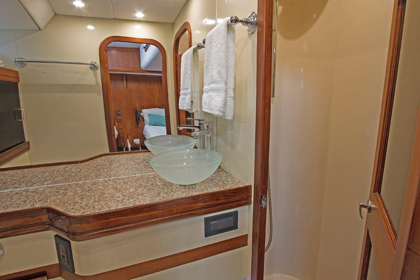 a bathroom with a countertop sink and mirror aboard EAGLES NEST Yacht for Sale