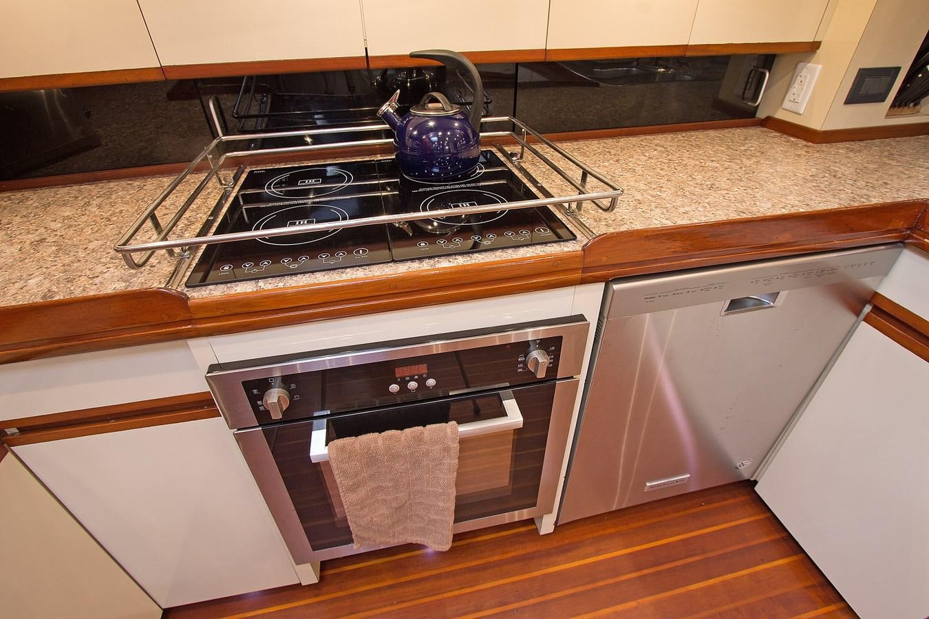 a kitchen with a stove and a tea kettle on the stove aboard EAGLES NEST Yacht for Sale