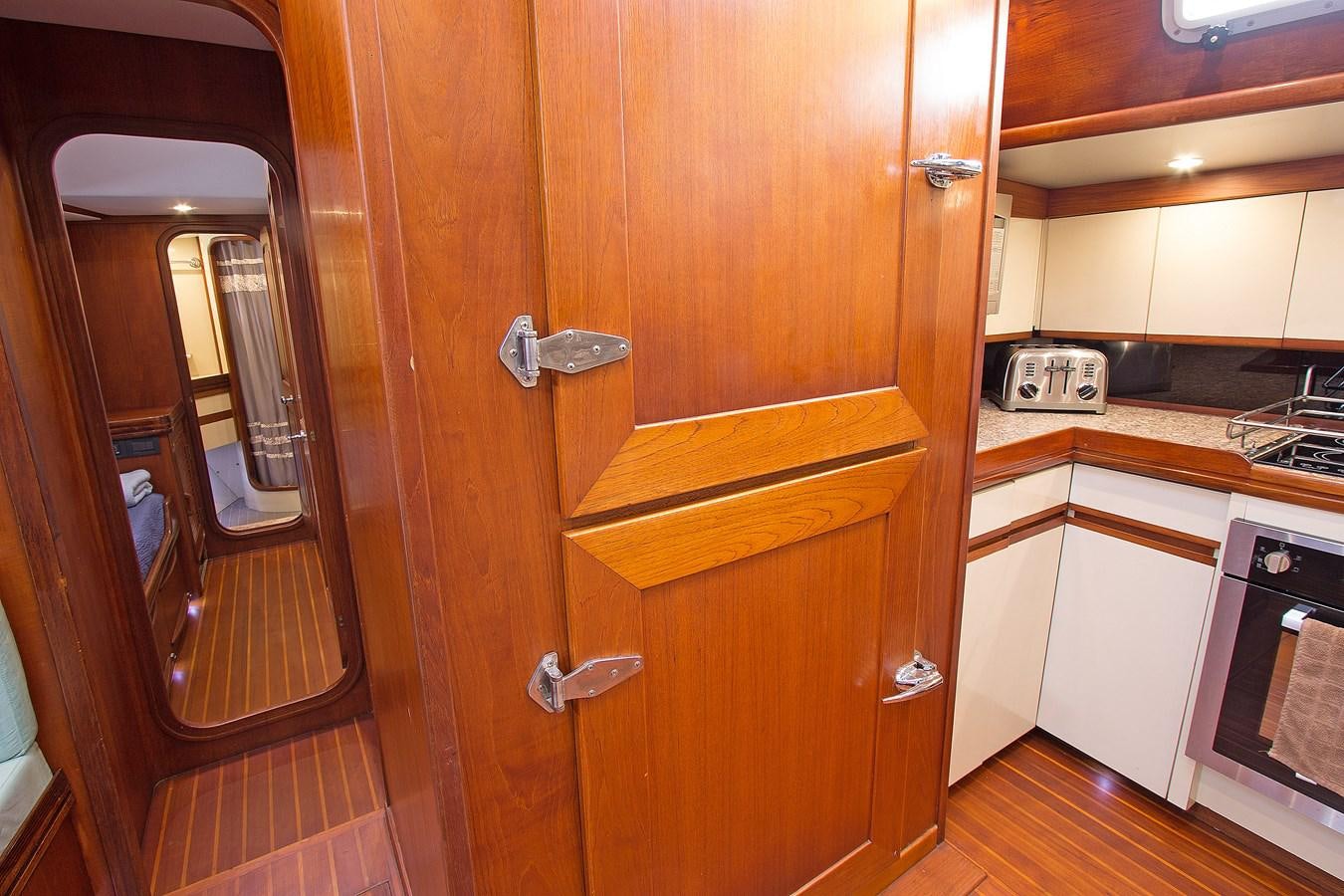 a kitchen with wooden cabinets aboard EAGLES NEST Yacht for Sale