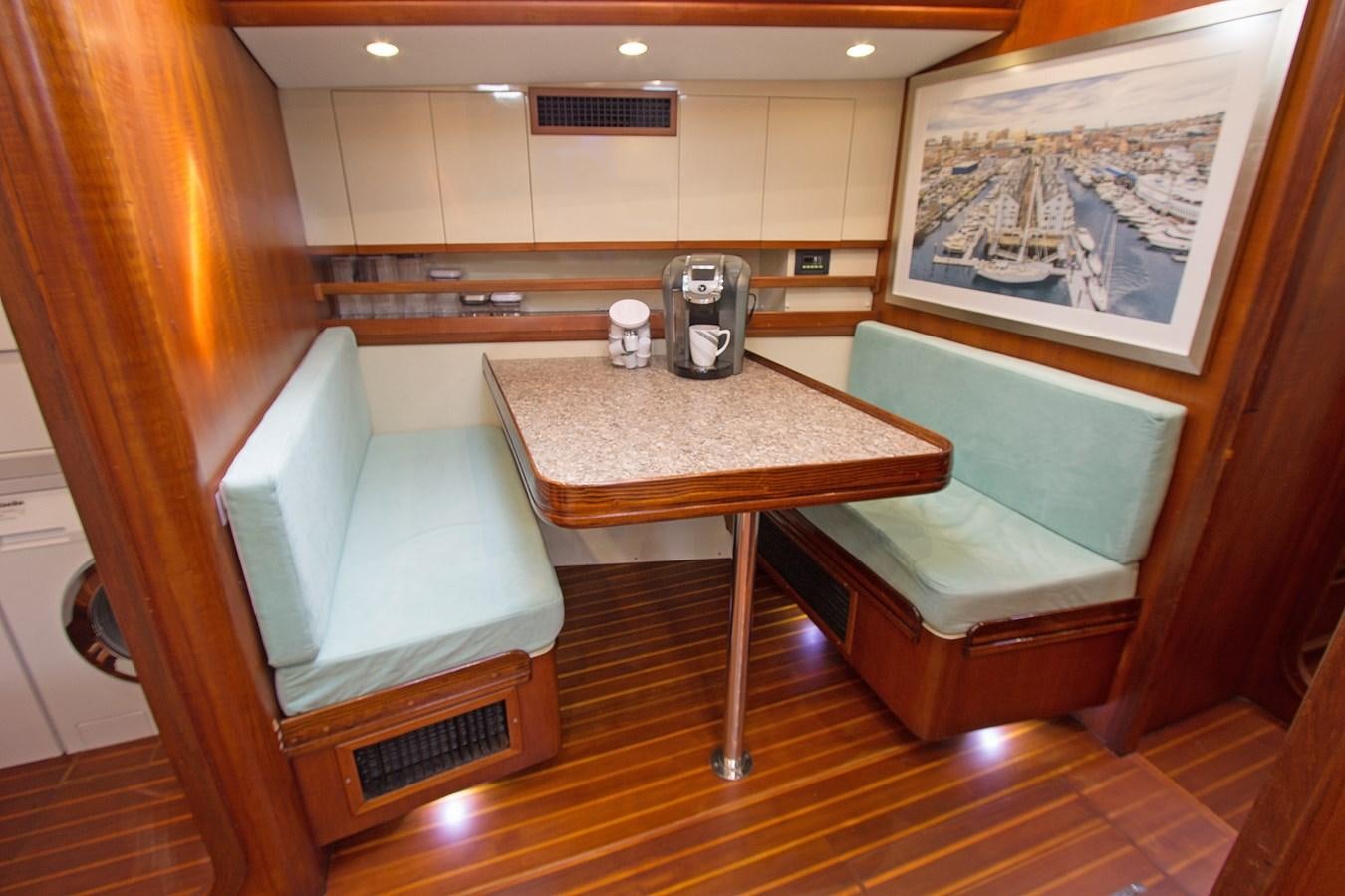 a room with a table and chairs aboard EAGLES NEST Yacht for Sale