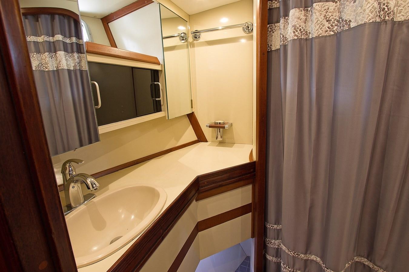 a bathroom with a sink and mirror aboard EAGLES NEST Yacht for Sale
