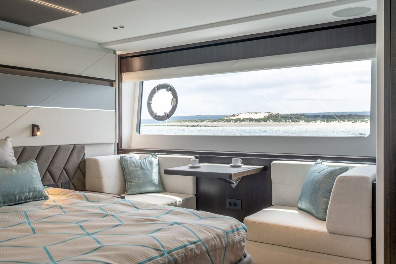 a room with a bed and a large window aboard 75 SPORT YACHT Yacht for Sale