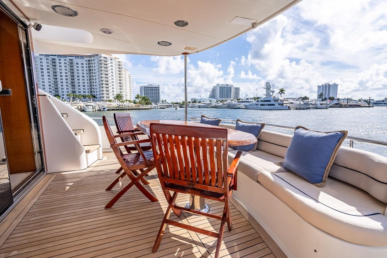 a room with a couch and a table and chairs on a deck aboard EDITA  Yacht for Sale