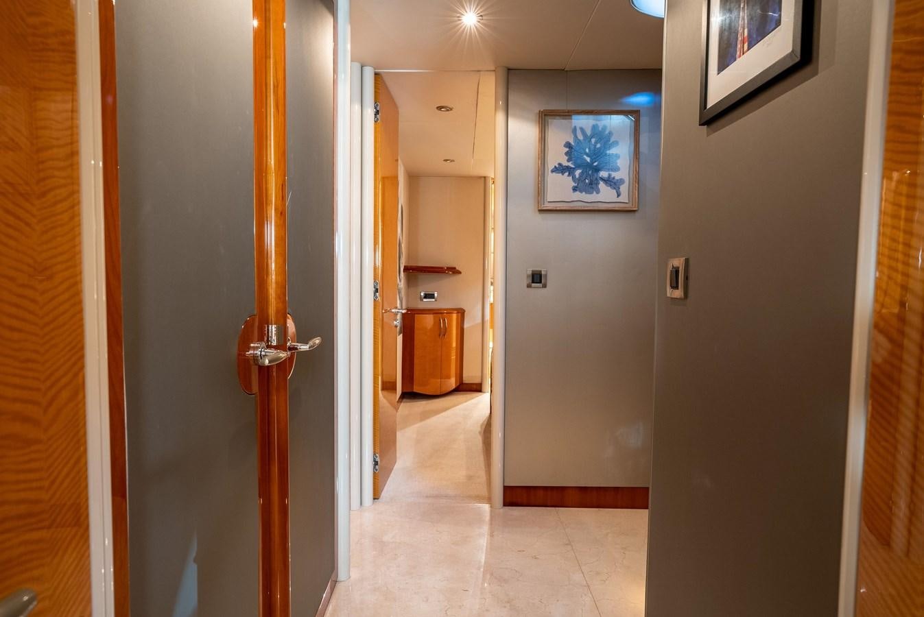 a hallway with a door and a painting on the wall aboard EDITA  Yacht for Sale
