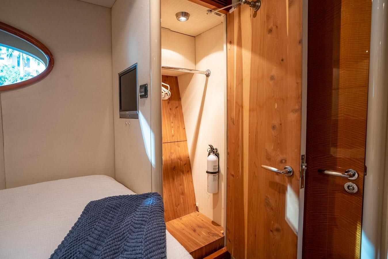 a room with a bed and a door aboard EDITA  Yacht for Sale