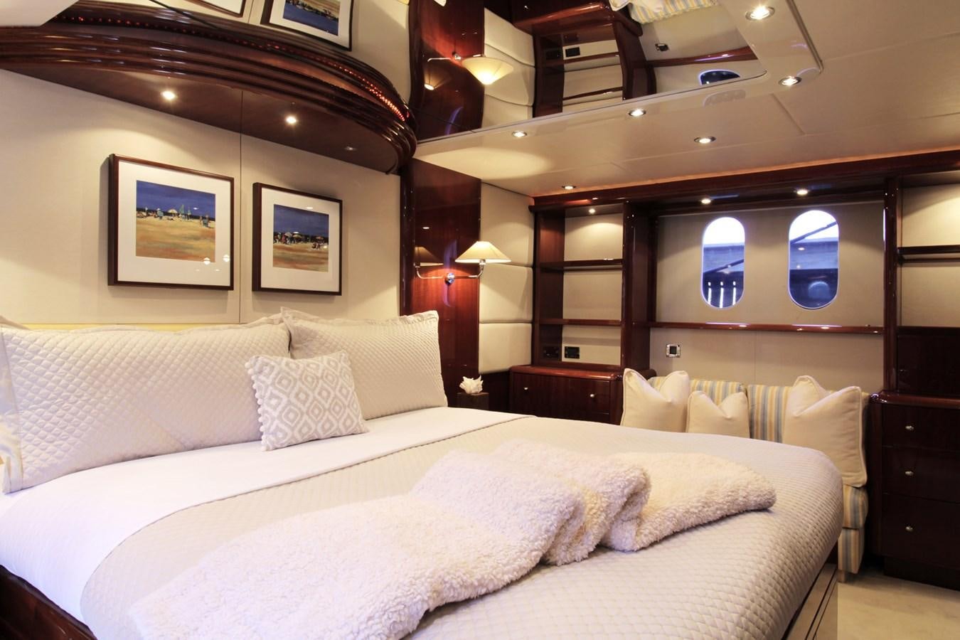 a bed with a white comforter aboard ARENITA Yacht for Sale
