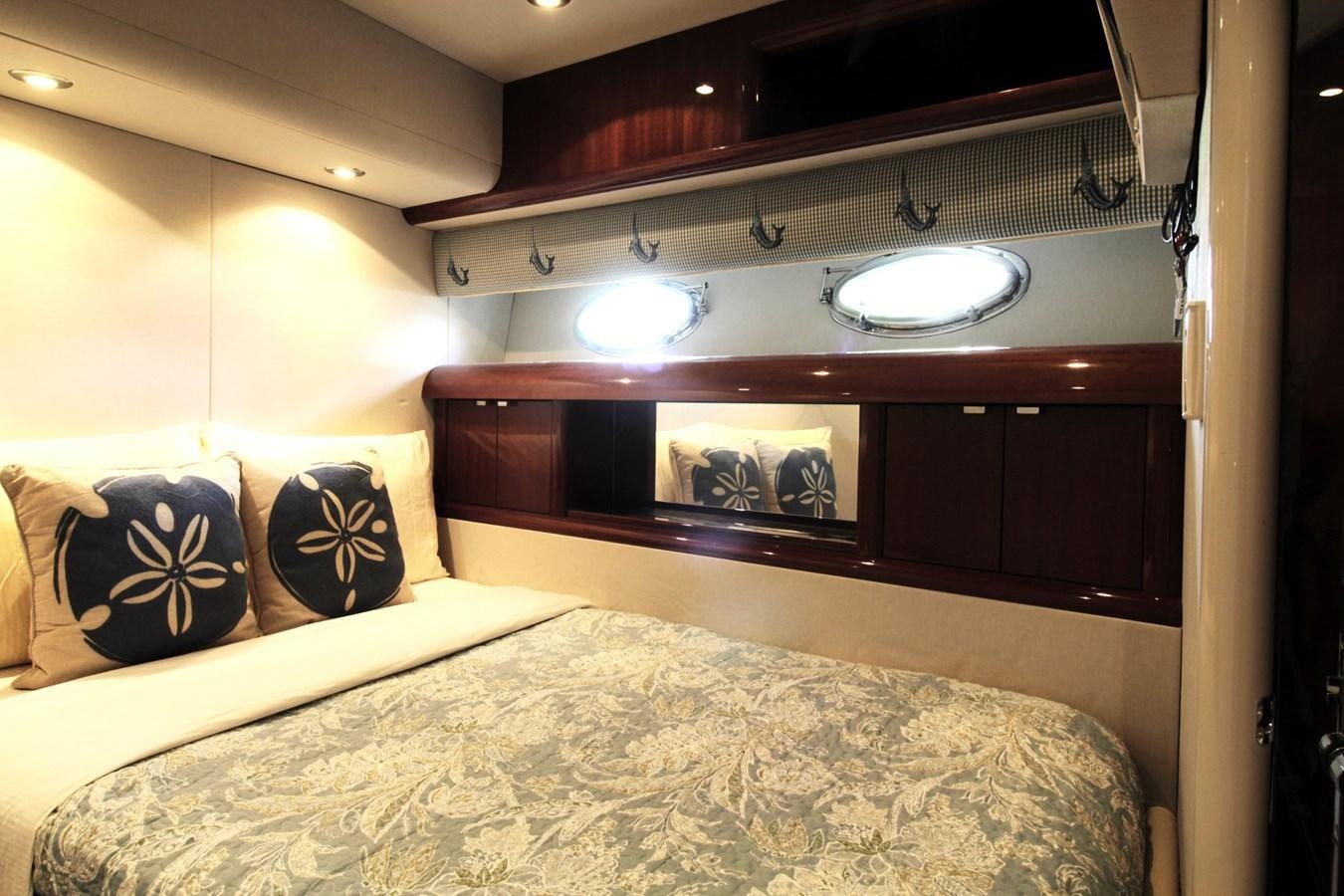 a bed with a wooden headboard aboard ARENITA Yacht for Sale
