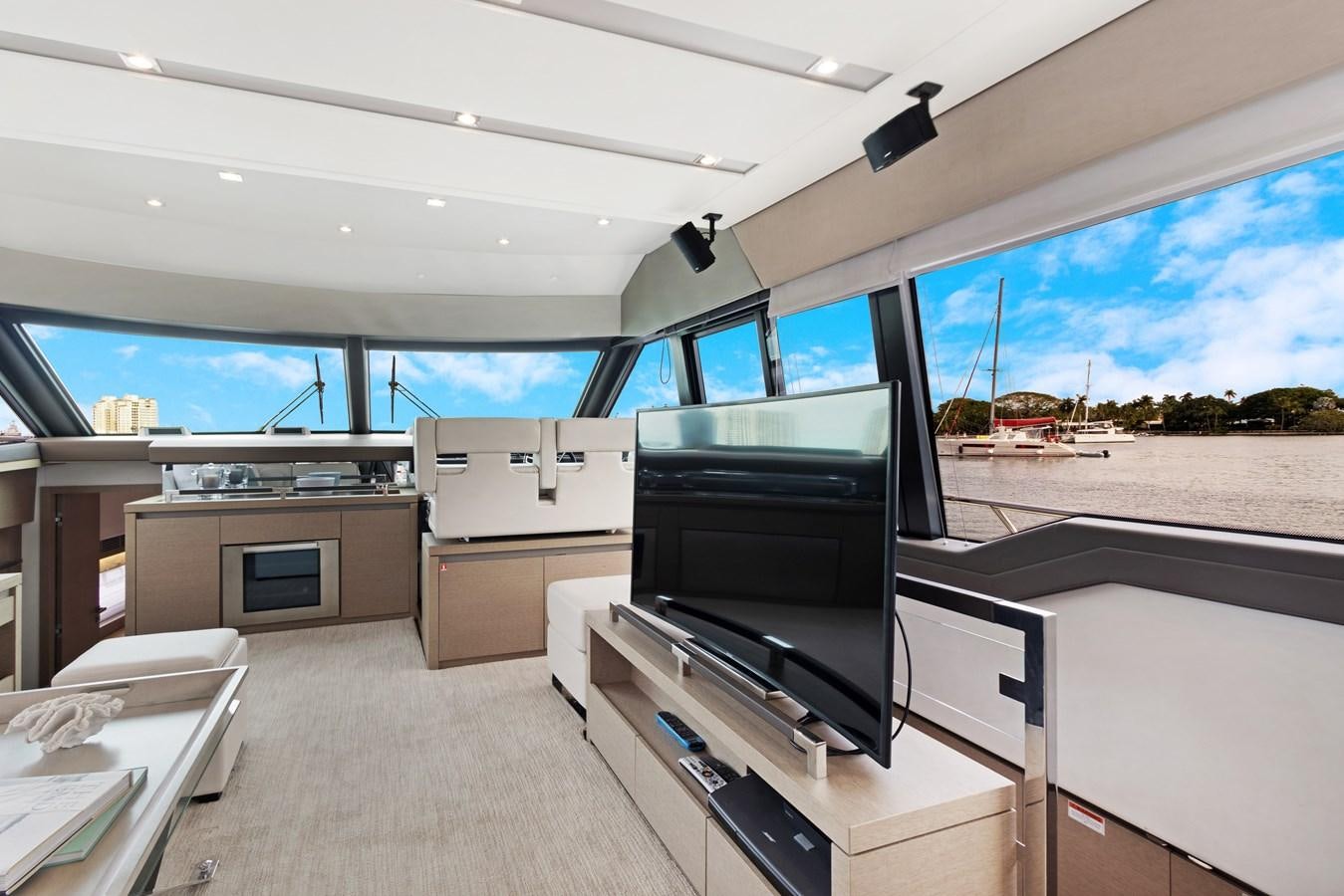 a room with a tv and a large window aboard JUIL OF THE SEA Yacht for Sale