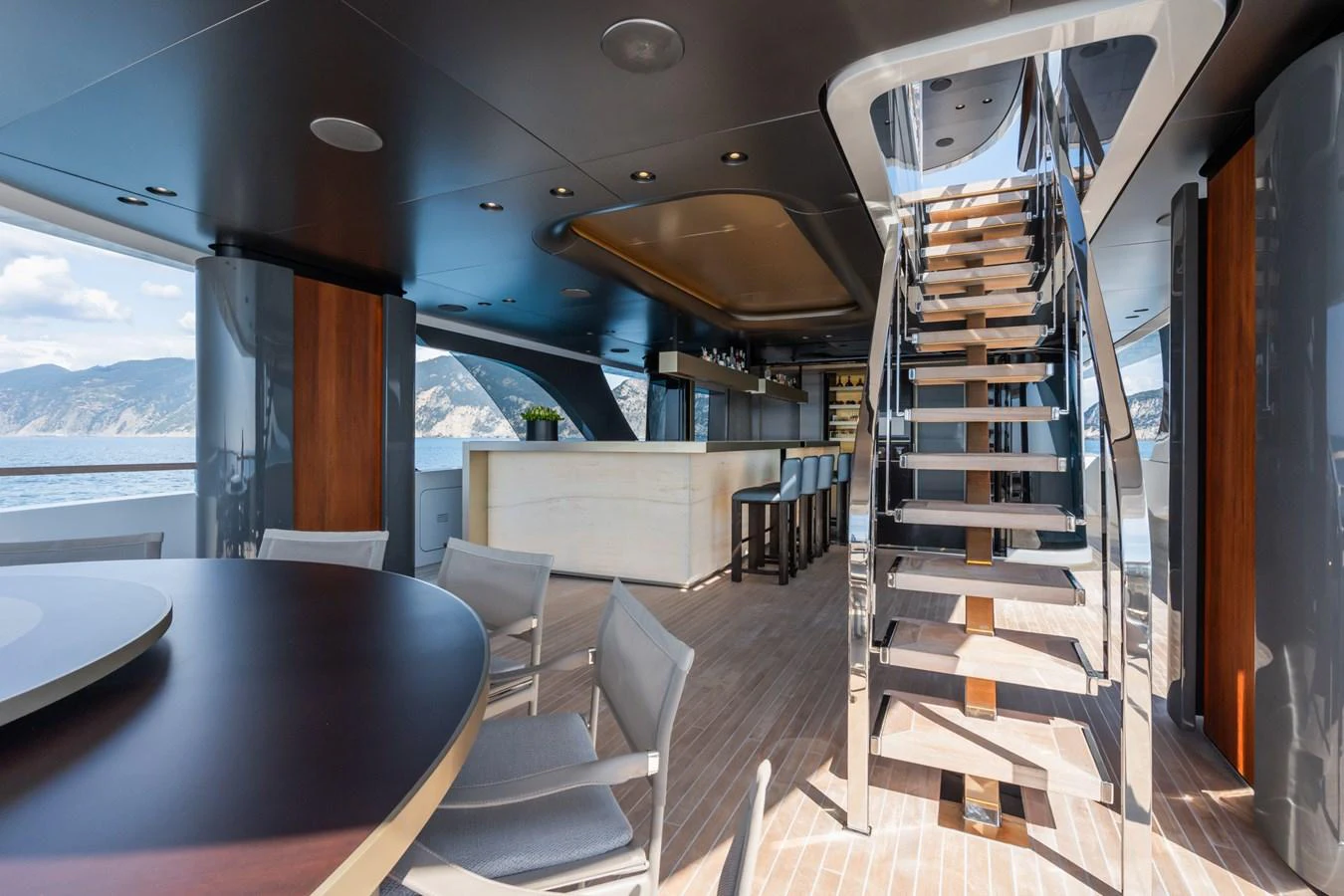 a room with a table chairs and a large window aboard SILVER STAR I Yacht for Sale