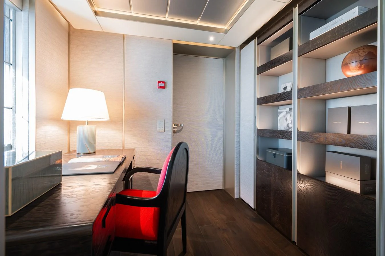 a room with a desk and a shelf with books on it aboard SILVER STAR I Yacht for Sale