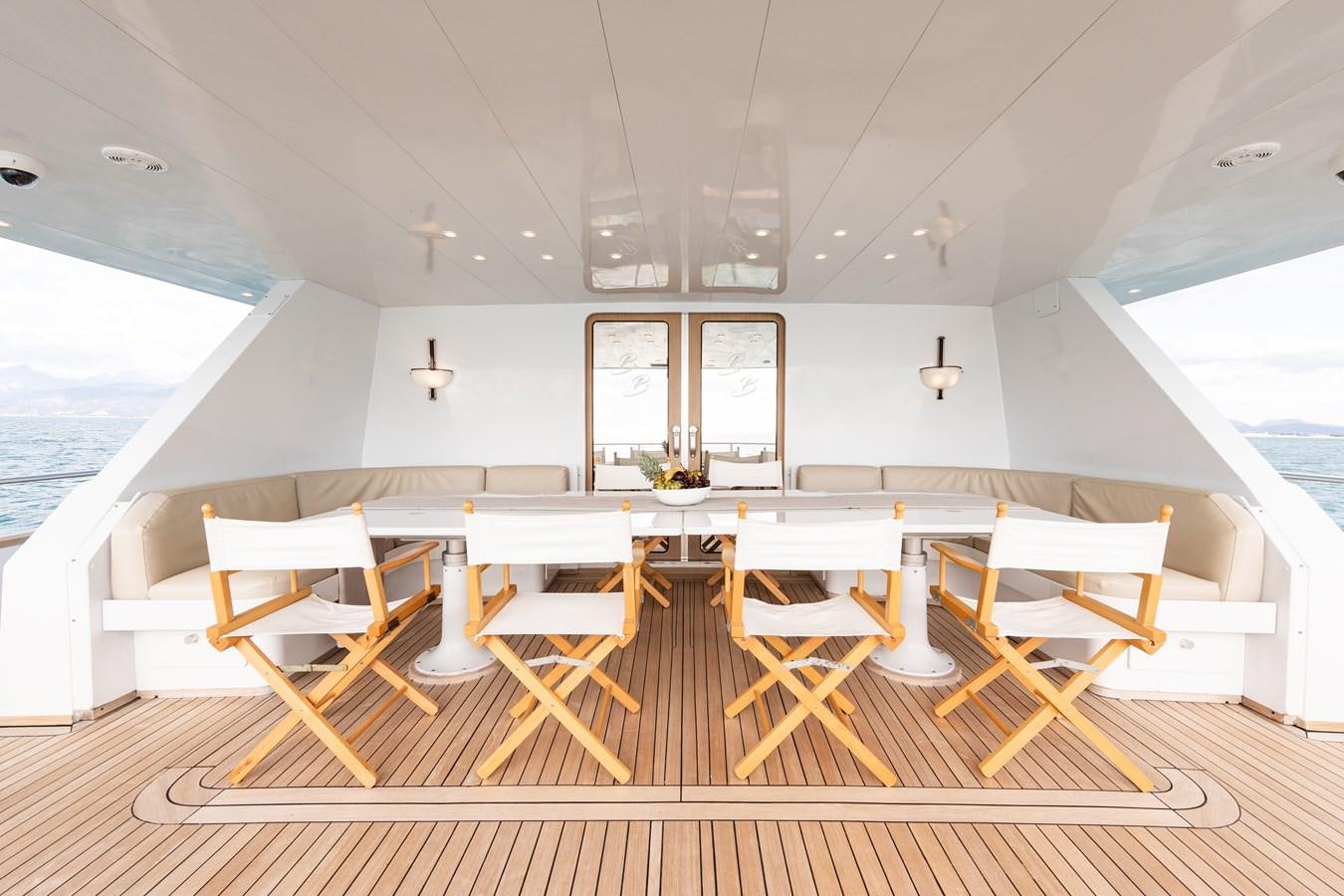 a room with tables and chairs aboard BABY BOSS Yacht for Sale