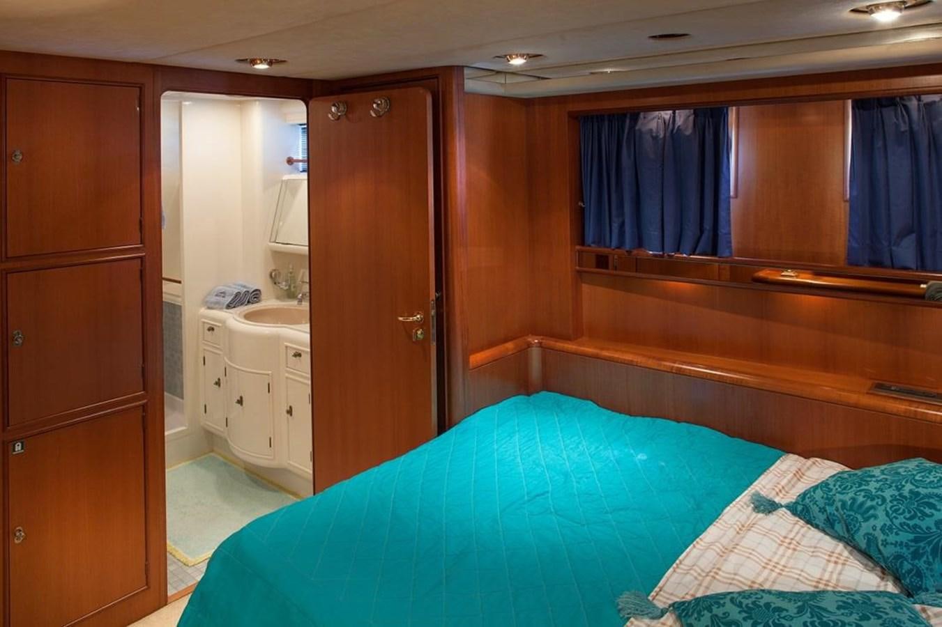 a bedroom with a bed and a closet aboard ARMATHIA Yacht for Sale