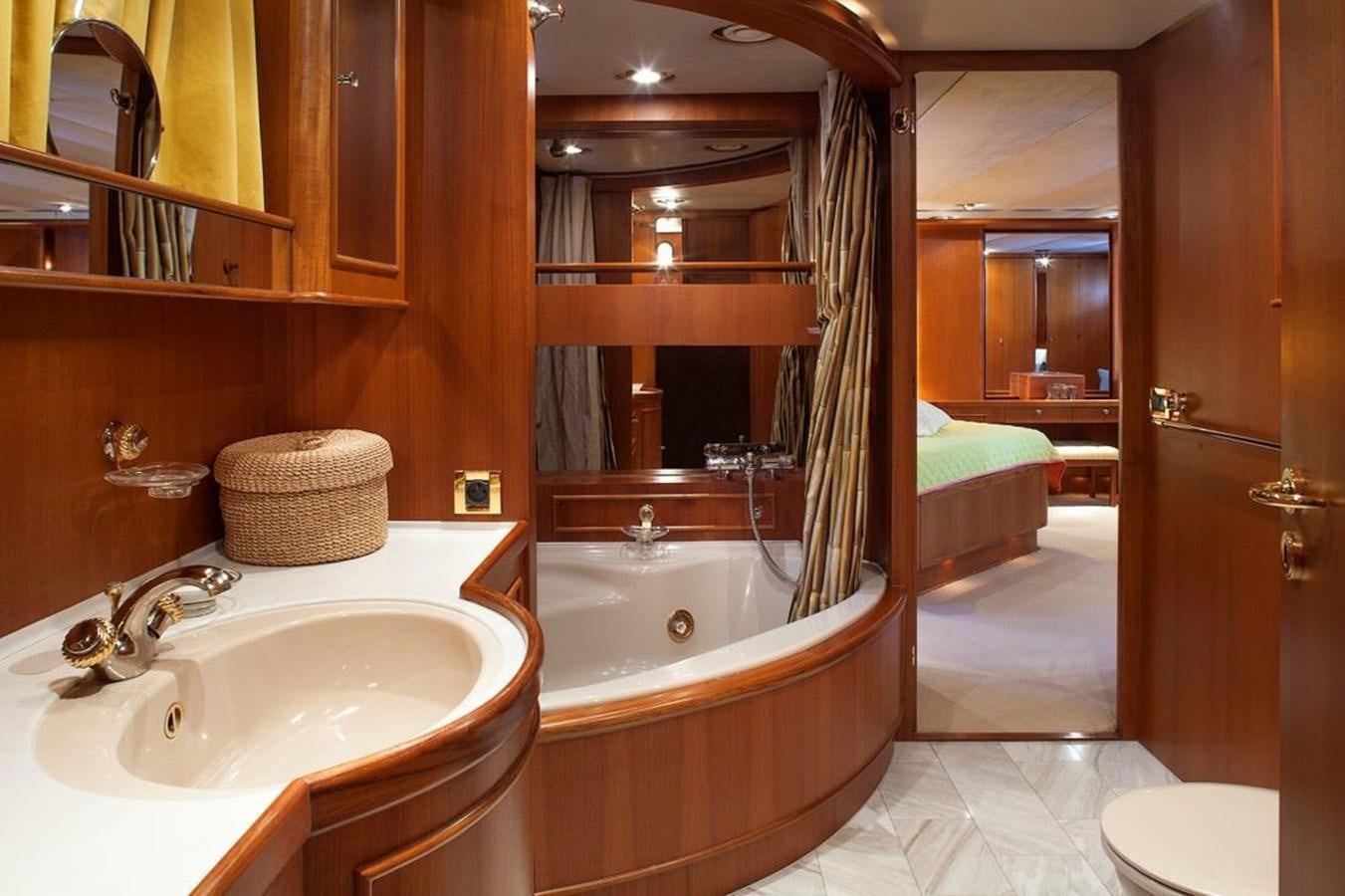 a bathroom with a tub sink and a mirror aboard ARMATHIA Yacht for Sale
