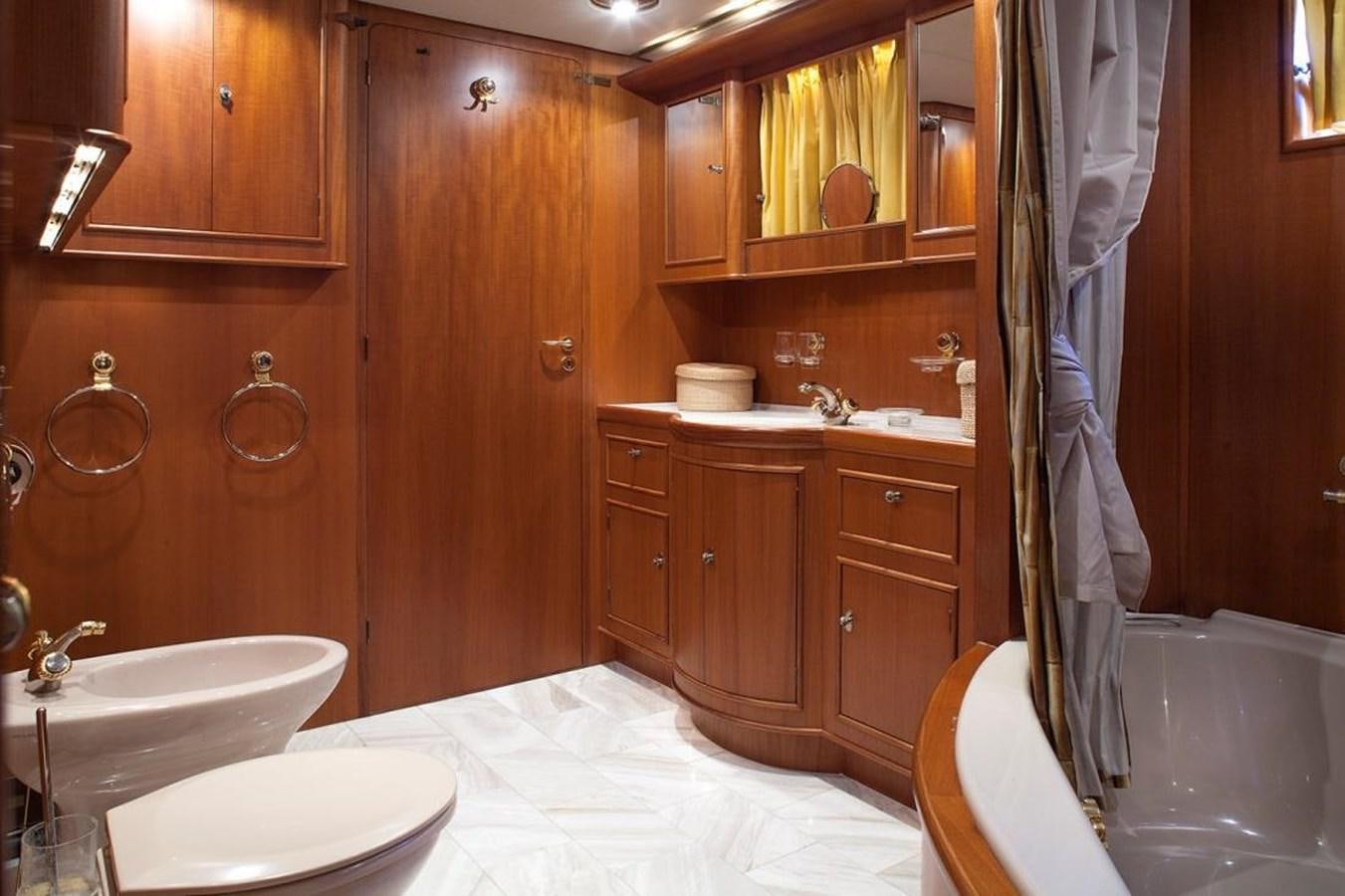 a bathroom with wooden cabinets aboard ARMATHIA Yacht for Sale