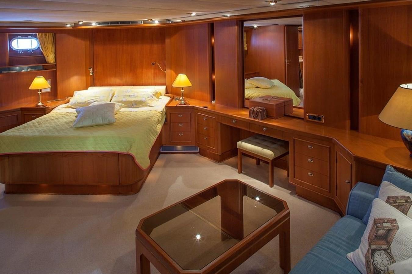 a room with a bed and a table aboard ARMATHIA Yacht for Sale
