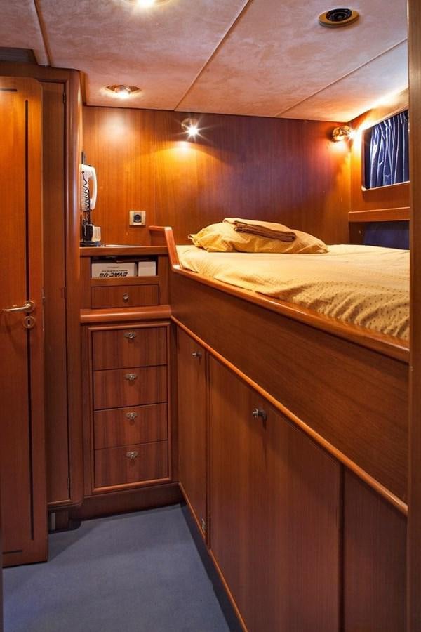 a bedroom with wooden cabinets aboard ARMATHIA Yacht for Sale