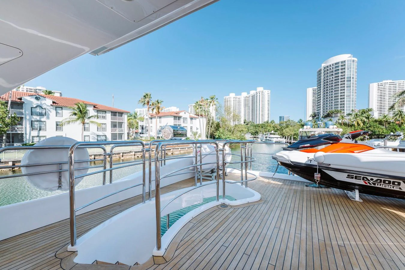 a deck with boats and buildings in the background aboard RESET Yacht for Sale
