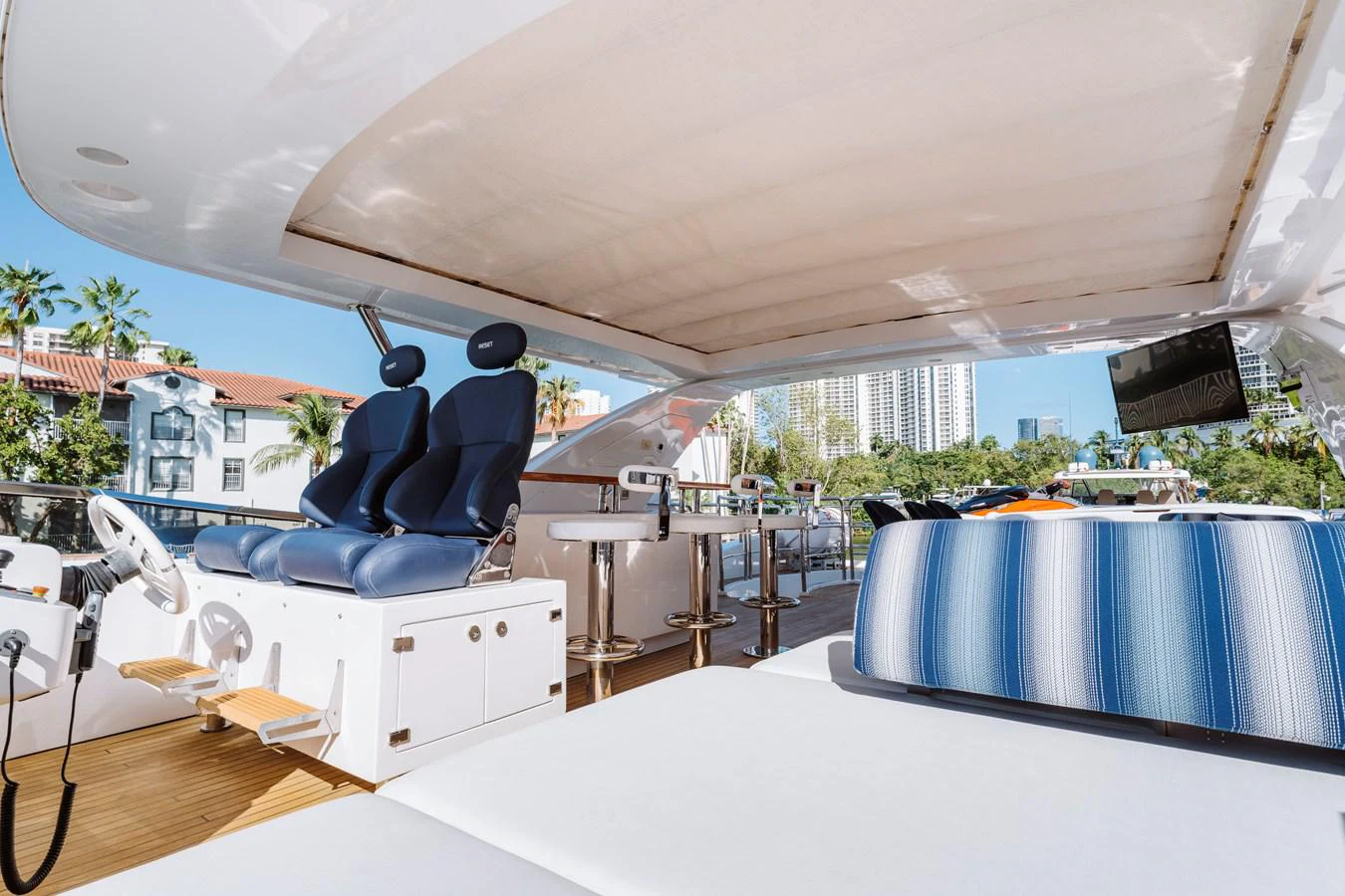 a lounge area with a lounge chair and a large blue lounge chair aboard RESET Yacht for Sale