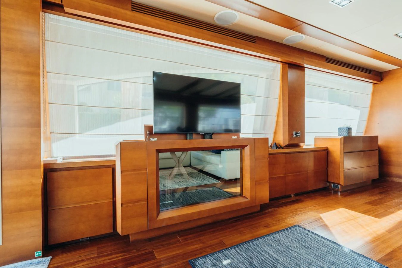 a room with a tv and a couch aboard RESET Yacht for Sale