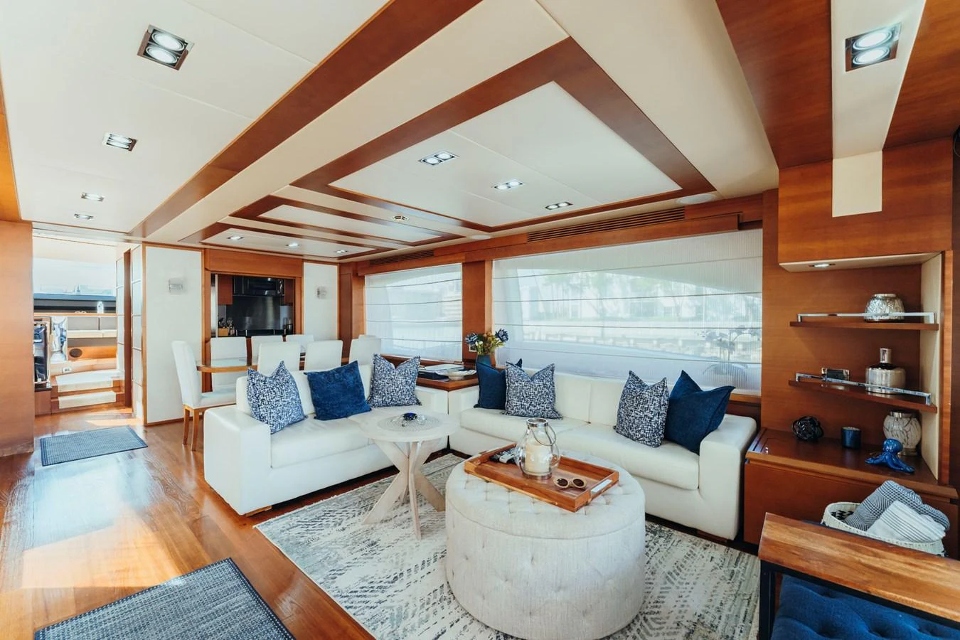 a living room with a white couch and a wood shelving unit aboard RESET Yacht for Sale