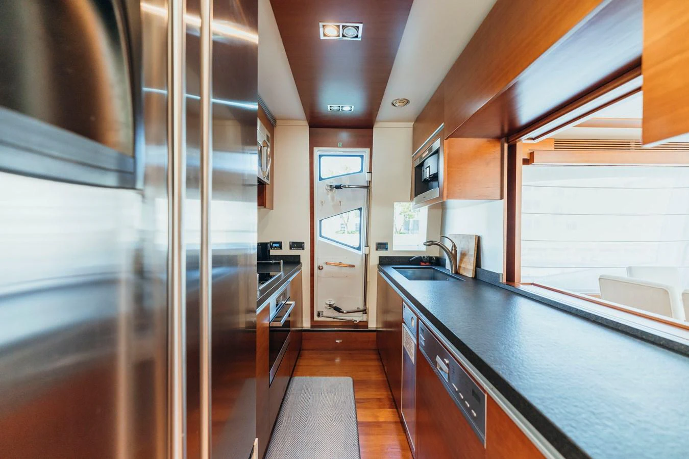 a kitchen with a large refrigerator aboard RESET Yacht for Sale